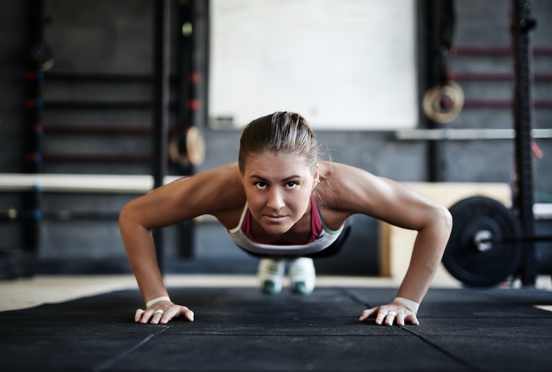 time under tension seen in woman doing pushups